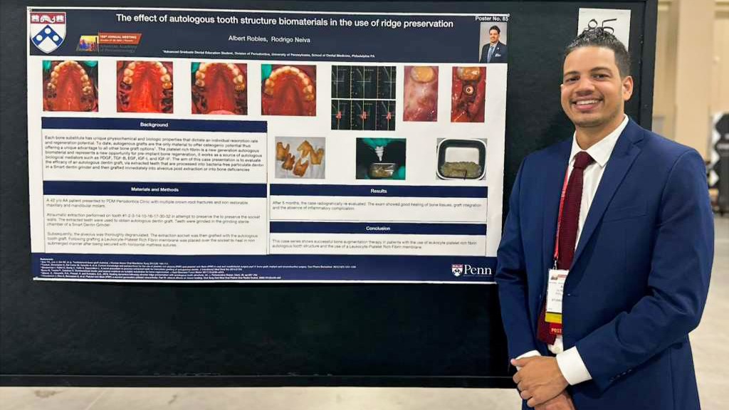 Dr. Albert Robles junto a un póster académico en un entorno de formación clínica